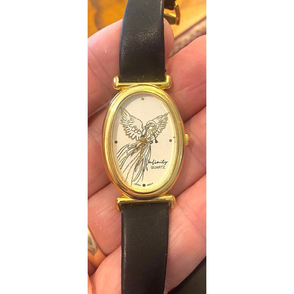 VTG Women's 25mm Gold Tone Infinity Watch, Trumpet Blowing Angel On Face